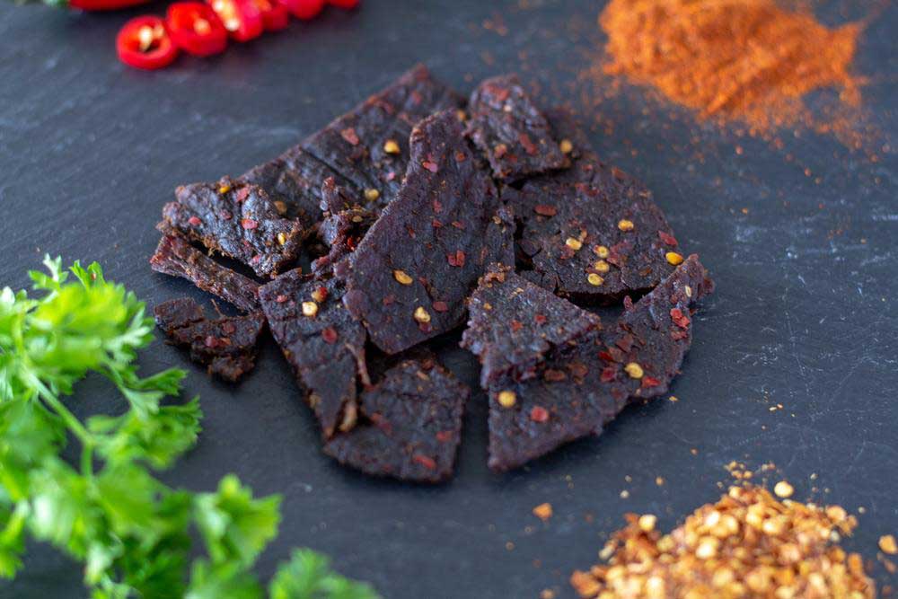 Perky Jerky beef jerky surrounded with tasty spices, herbs and chili peppers